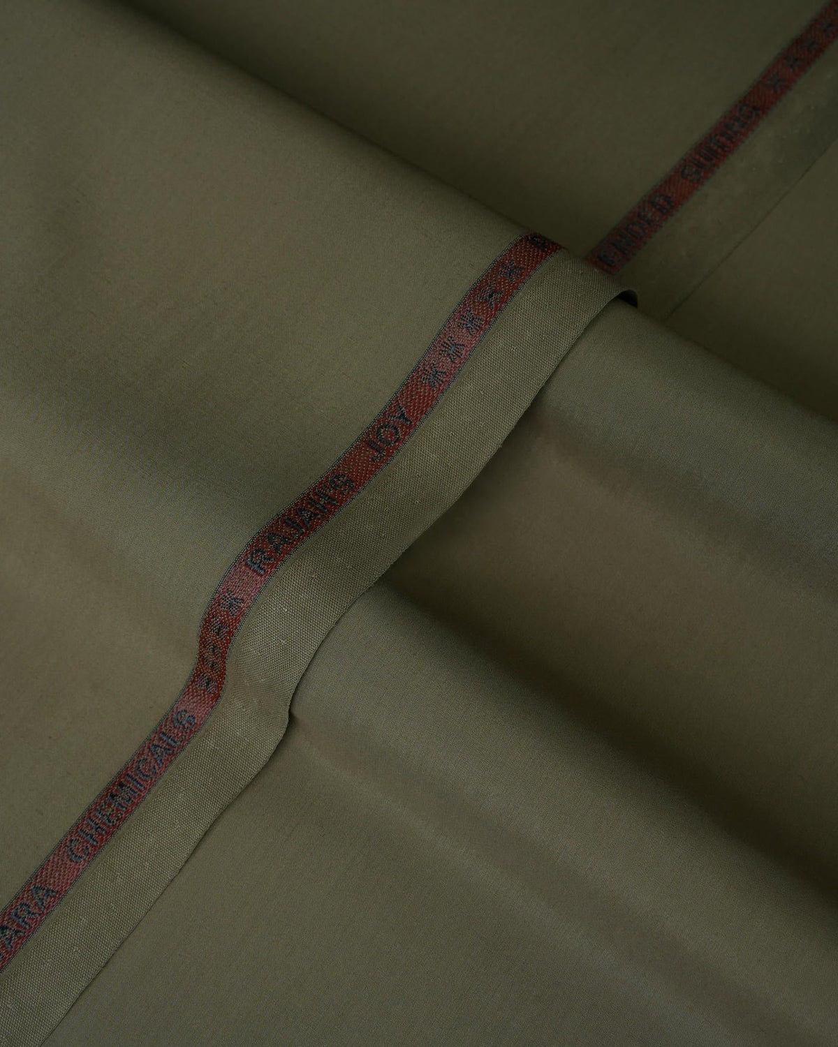 Joyful Comfort Blanket, soft cozy throw, cream color, folded on bed.