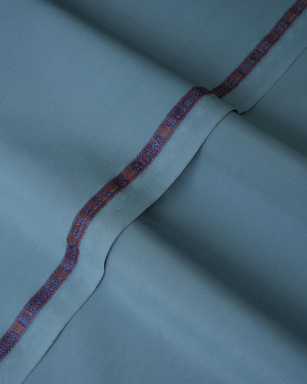Joyful Comfort Blanket, soft cozy throw, cream color, folded, on a bed. Image 4 of 10.